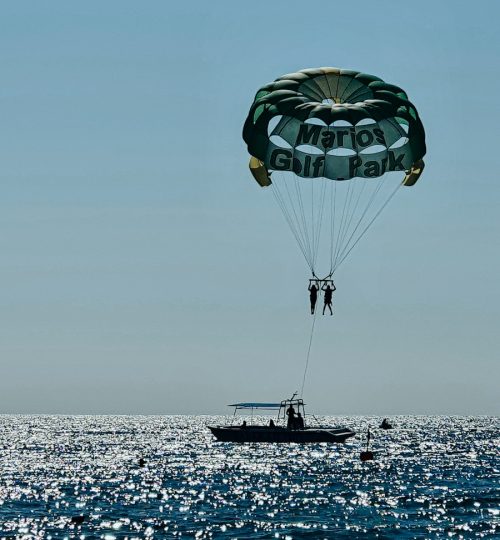 a person parasailing over a boat