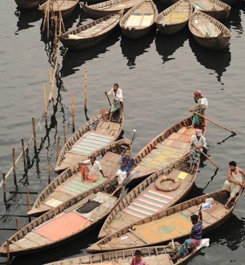 a number of small boats in a body of water